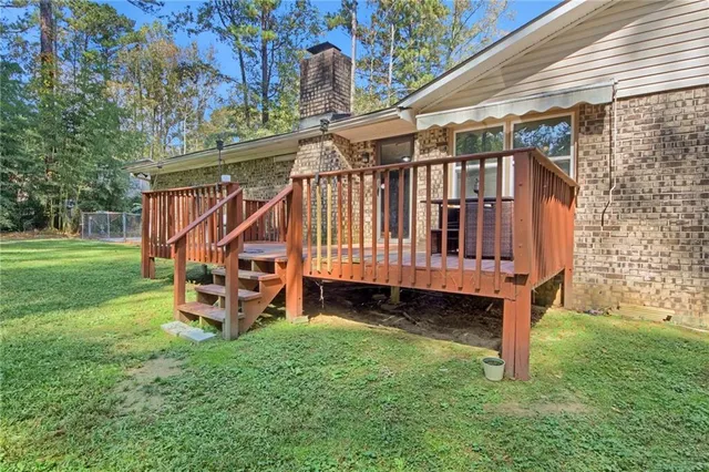 a view of a house with a yard and sitting area