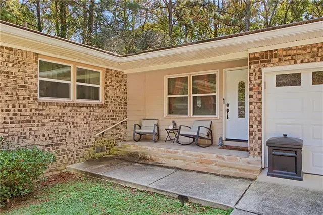 a front view of a house with large windows