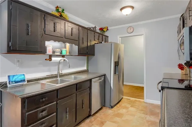 a kitchen with a sink and a refrigerator