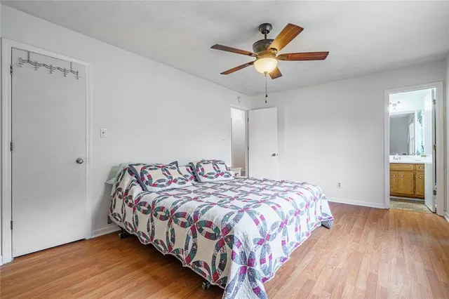 a bedroom with bed and a chandelier