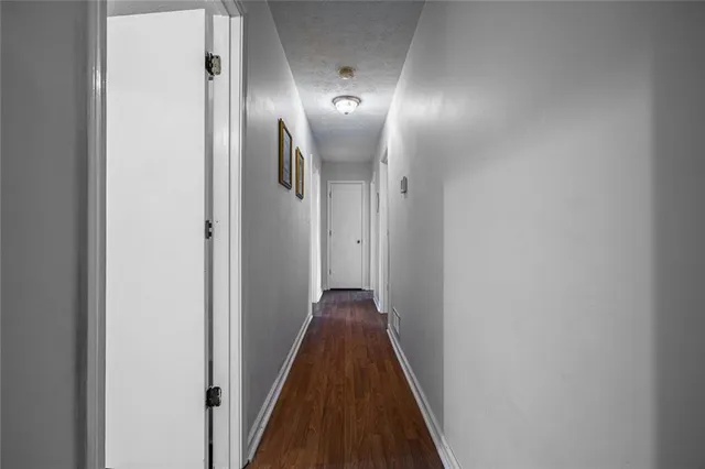 a view of hallway with wooden floor