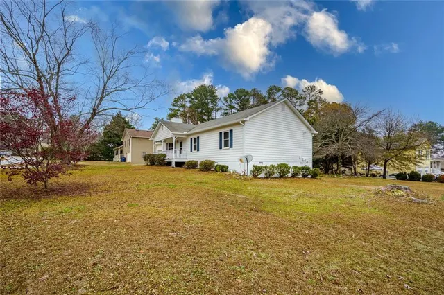 a view of a house with a yard and garage