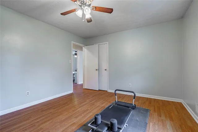 a room with wooden floor and chandelier