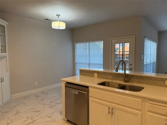 a kitchen with a sink and cabinets