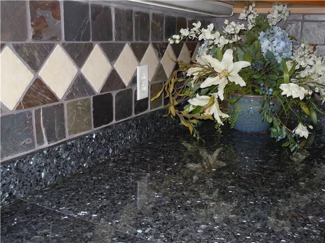 7100 Dale Ridge Road, Unit J4 Lancaster, TN 38569 - Photo 11 of 20 Close up of detailed tile backsplash and granite counter tops