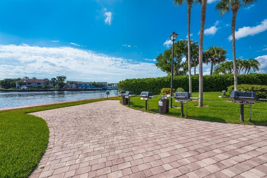 899 Jeffery Street, Unit 703 Boca Raton, FL 33487 - Photo 9 of 22 a view of a swimming pool and trees in the background