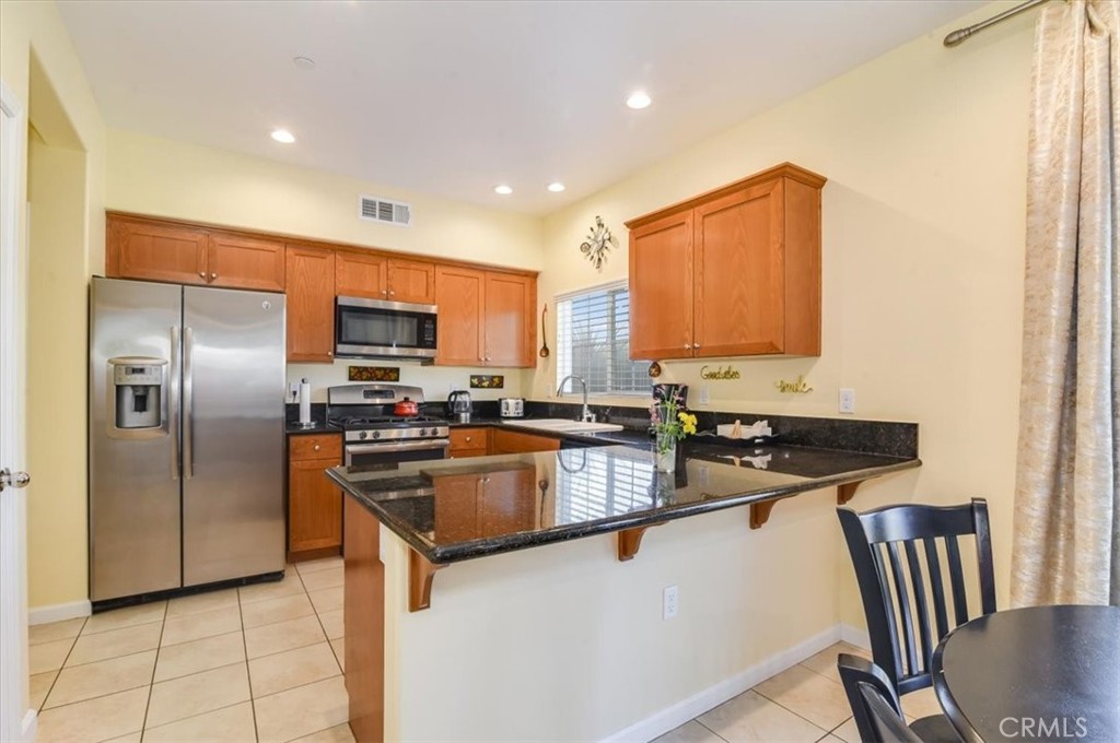 1213 Meridian Way Lompoc, CA 93436 - Photo 14 of 37 a kitchen with stainless steel appliances granite countertop a refrigerator stove microwave and sink