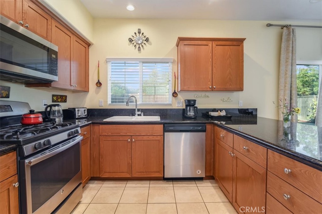 1213 Meridian Way Lompoc, CA 93436 - Photo 15 of 37 a kitchen with stainless steel appliances granite countertop a sink stove and microwave