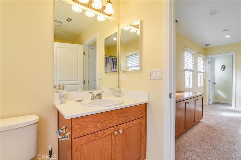 1213 Meridian Way Lompoc, CA 93436 - Photo 20 of 37 a bathroom with a sink a toilet and a mirror
