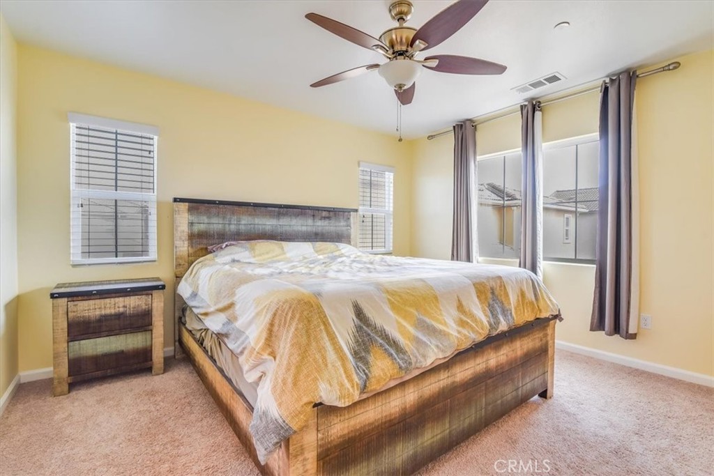 1213 Meridian Way Lompoc, CA 93436 - Photo 21 of 37 a bed sitting in a spacious bedroom next to a window