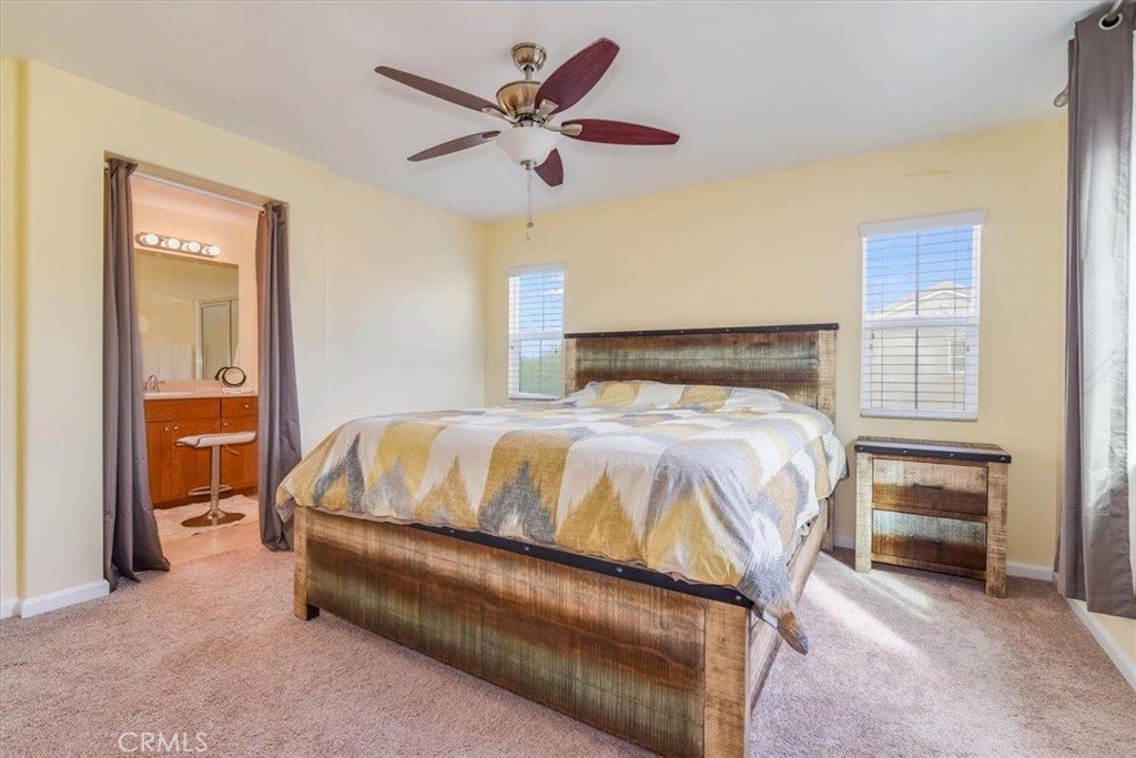 1213 Meridian Way Lompoc, CA 93436 - Photo 22 of 37 a bedroom with a bed and a chandelier