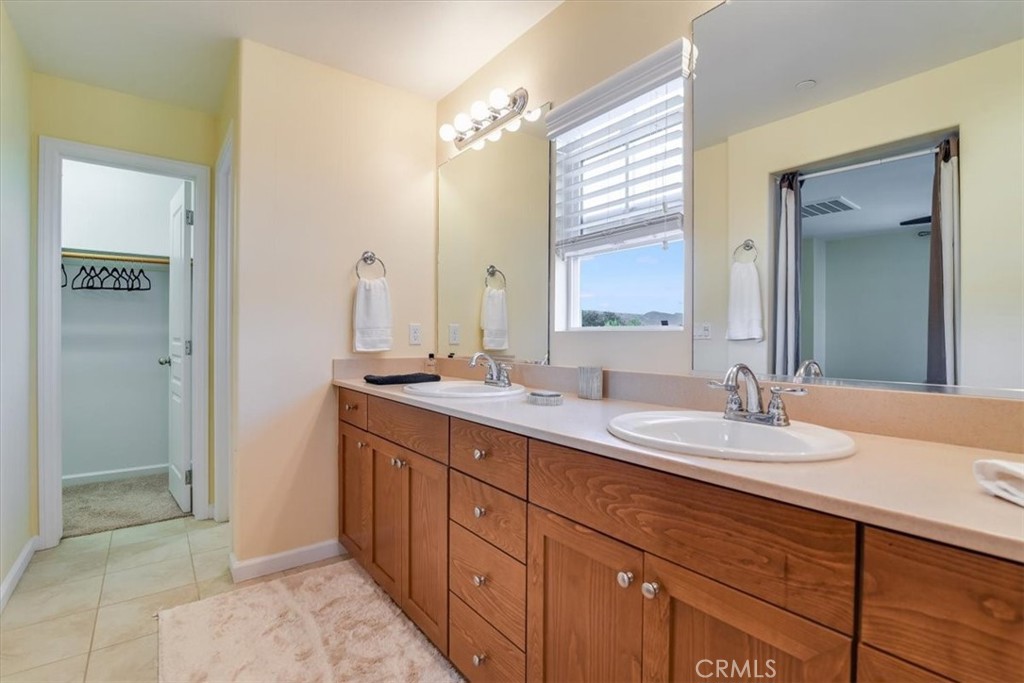 1213 Meridian Way Lompoc, CA 93436 - Photo 24 of 37 a bathroom with a double vanity sink and a mirror