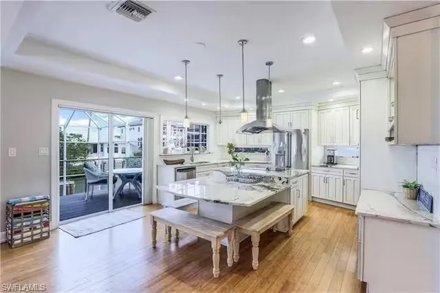 a large kitchen with a table and chairs in it