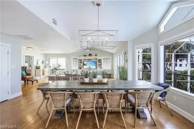 a view of a dining room with furniture wooden floor and chandelier