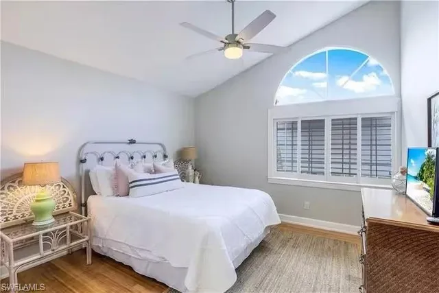 a bedroom with a large bed and a window