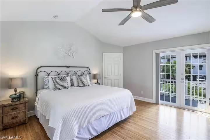 437 Trade Winds Avenue Naples, FL 34108 - Photo 18 of 33 a bedroom with a bed and wooden floor