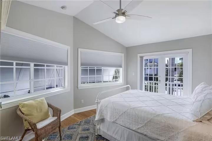 437 Trade Winds Avenue Naples, FL 34108 - Photo 20 of 33 a bedroom with a large bed and a window