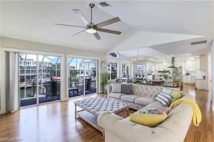 437 Trade Winds Avenue Naples, FL 34108 - Photo 2 of 33 a living room with furniture and a large window