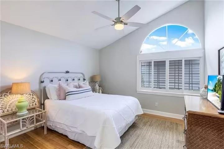 437 Trade Winds Avenue Naples, FL 34108 - Photo 21 of 33 a bedroom with a large bed and a window