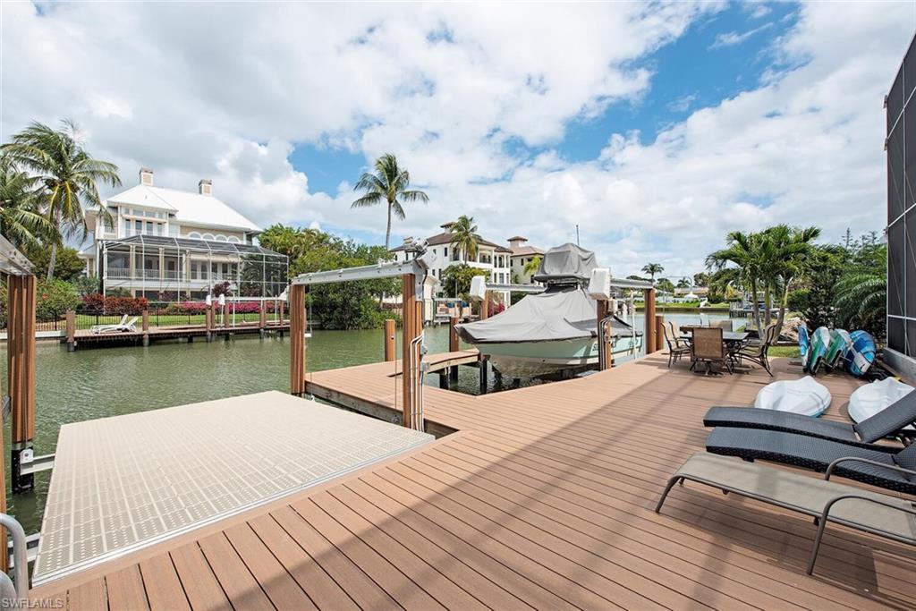 437 Trade Winds Avenue Naples, FL 34108 - Photo 25 of 33 a view of a lake with sitting area