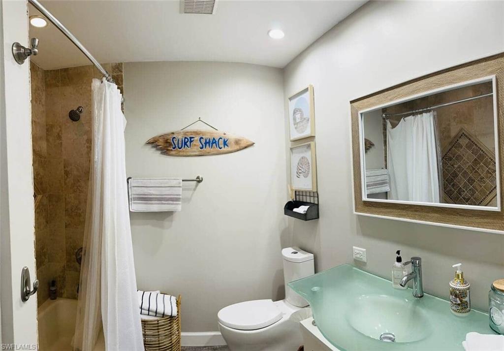 437 Trade Winds Avenue Naples, FL 34108 - Photo 31 of 33 a bathroom with a toilet sink and shower