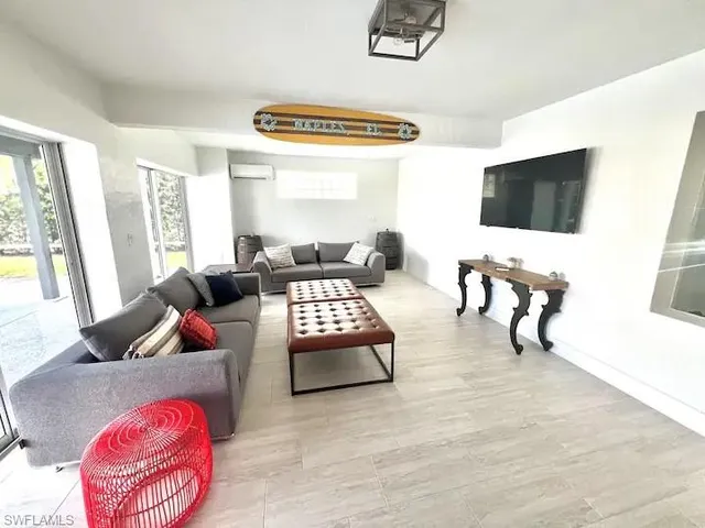 a living room with furniture and a flat screen tv