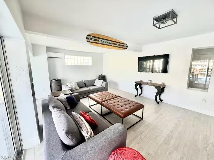 437 Trade Winds Avenue Naples, FL 34108 - Photo 7 of 33 a living room with furniture and a flat screen tv
