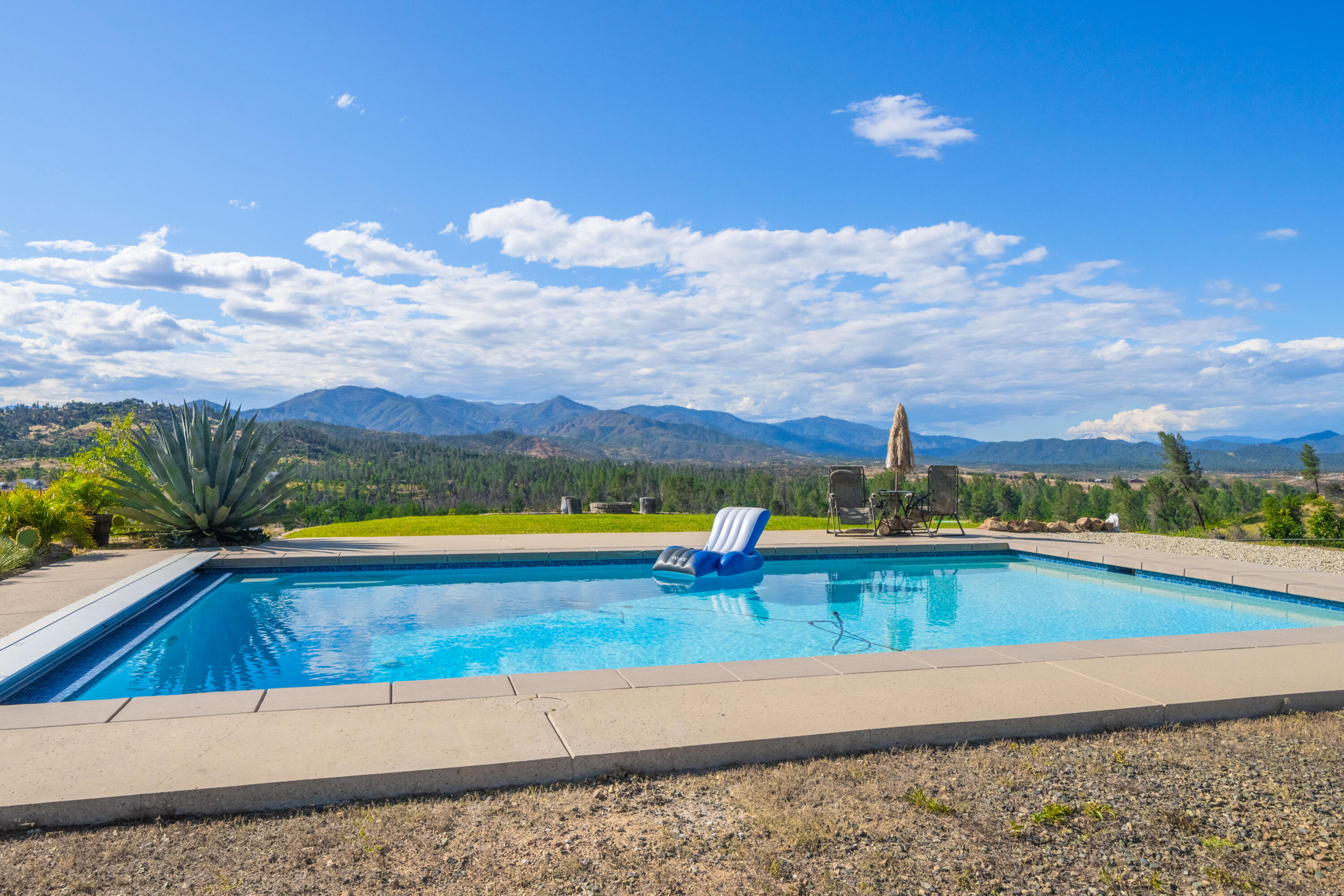 16275 Valparaiso Way Redding, CA 96001 - Photo 1 of 13 a view of a swimming pool and an ocean view