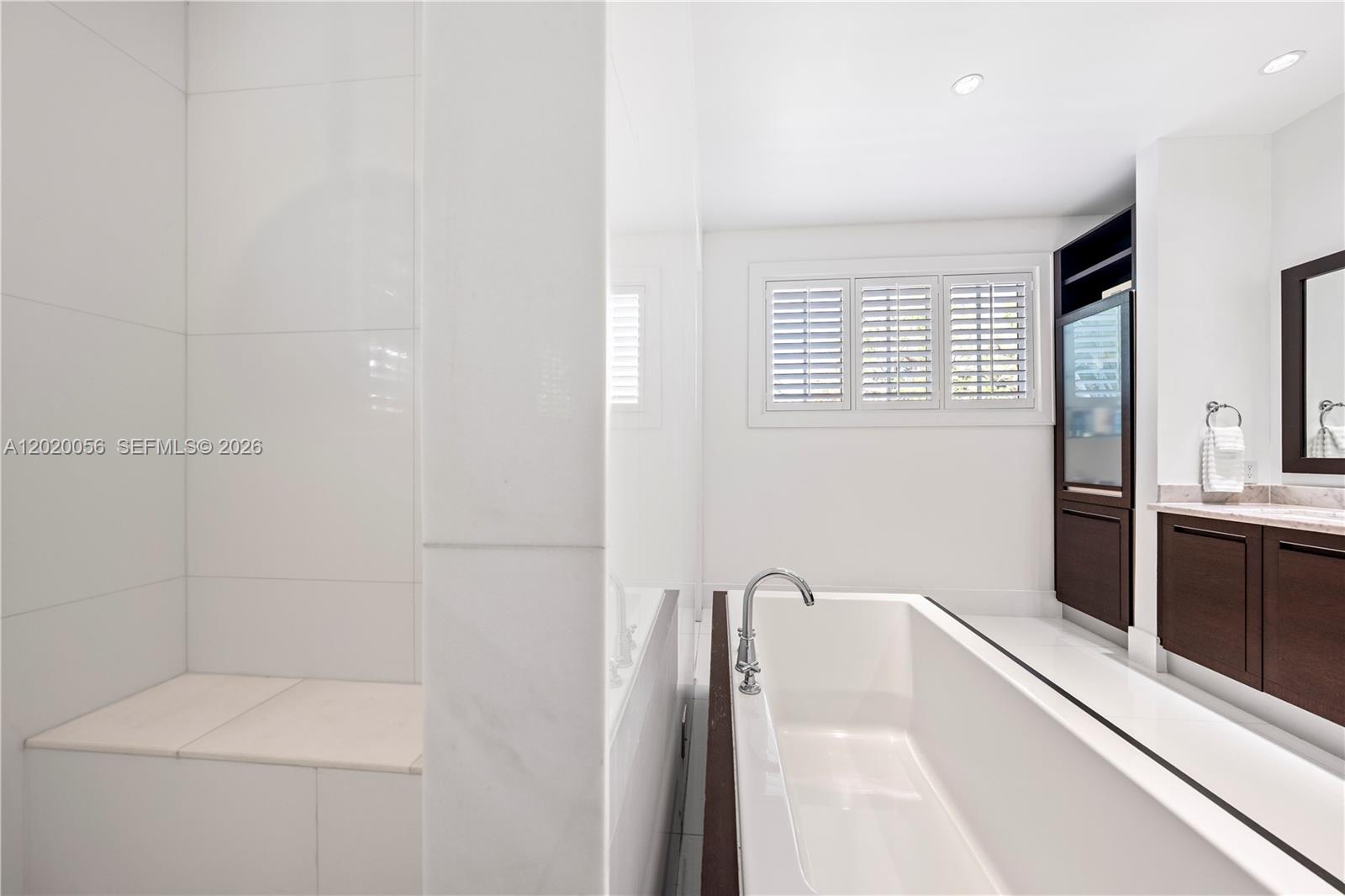 4196 Douglas Road Miami, FL 33133 - Photo 56 of 96 a bathroom with a bathtub and a shower