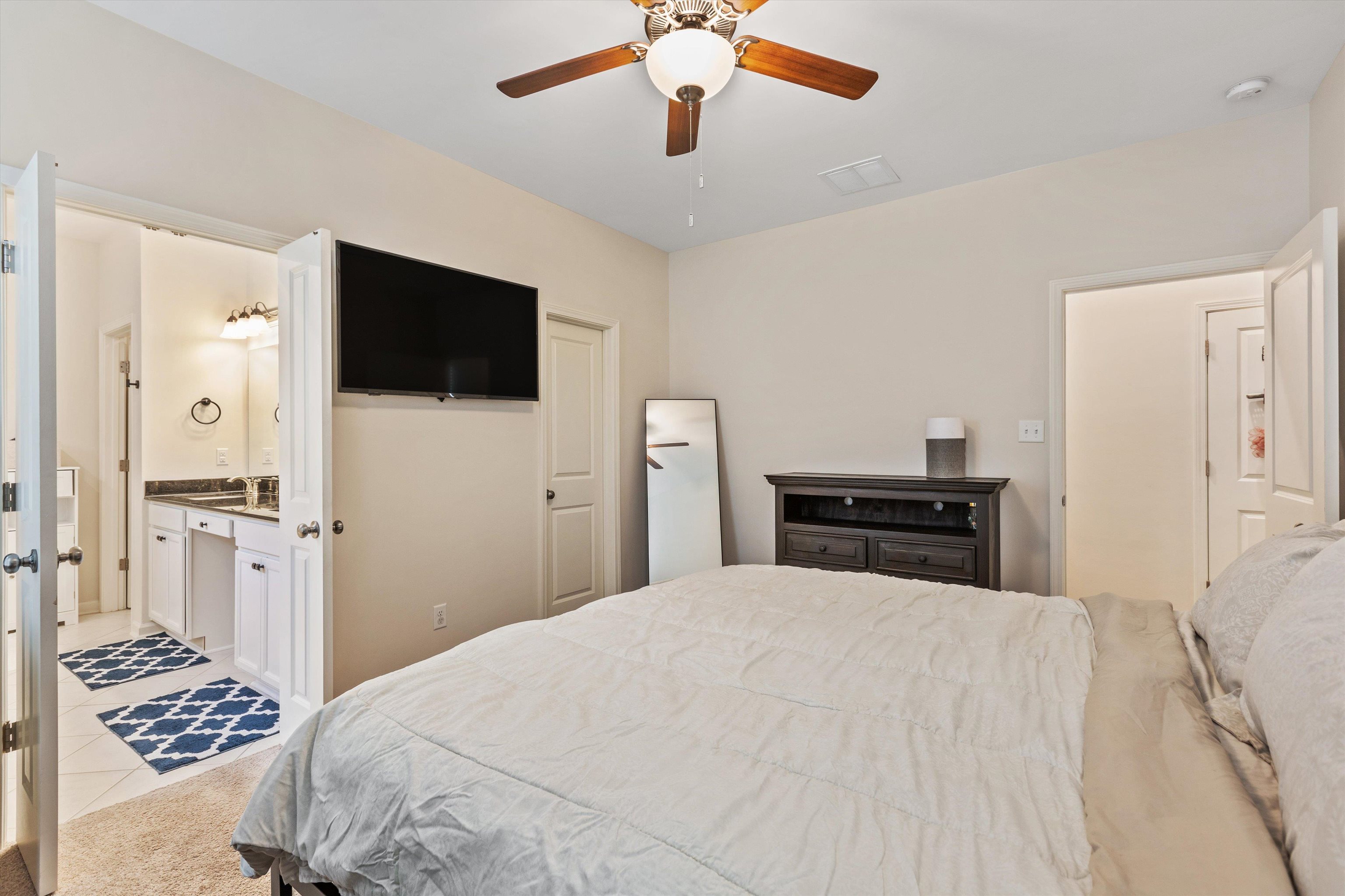 10139 Macon Road Cordova, TN 38018 - Photo 14 of 31 Bedroom featuring a ceiling fan with light fixture, wall-mounted television, and a neutral color palette