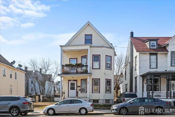 a front view of a residential apartment building with a yard