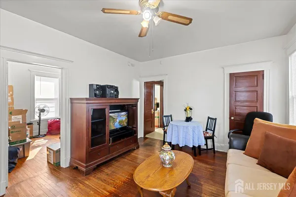 a bedroom with furniture and a flat screen tv
