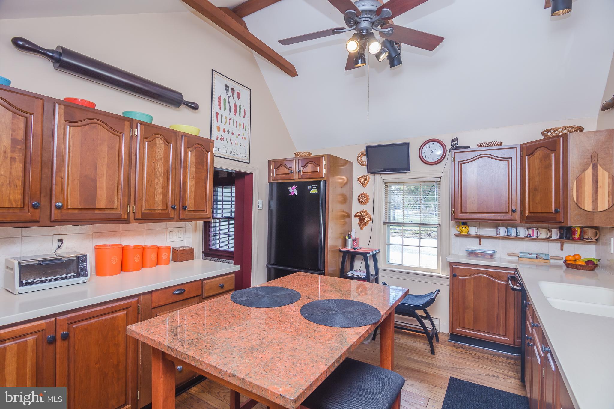 3387 Allen Road Eden, MD 21822 - Photo 23 of 67 a kitchen with stainless steel appliances granite countertop a table chairs in it and a window