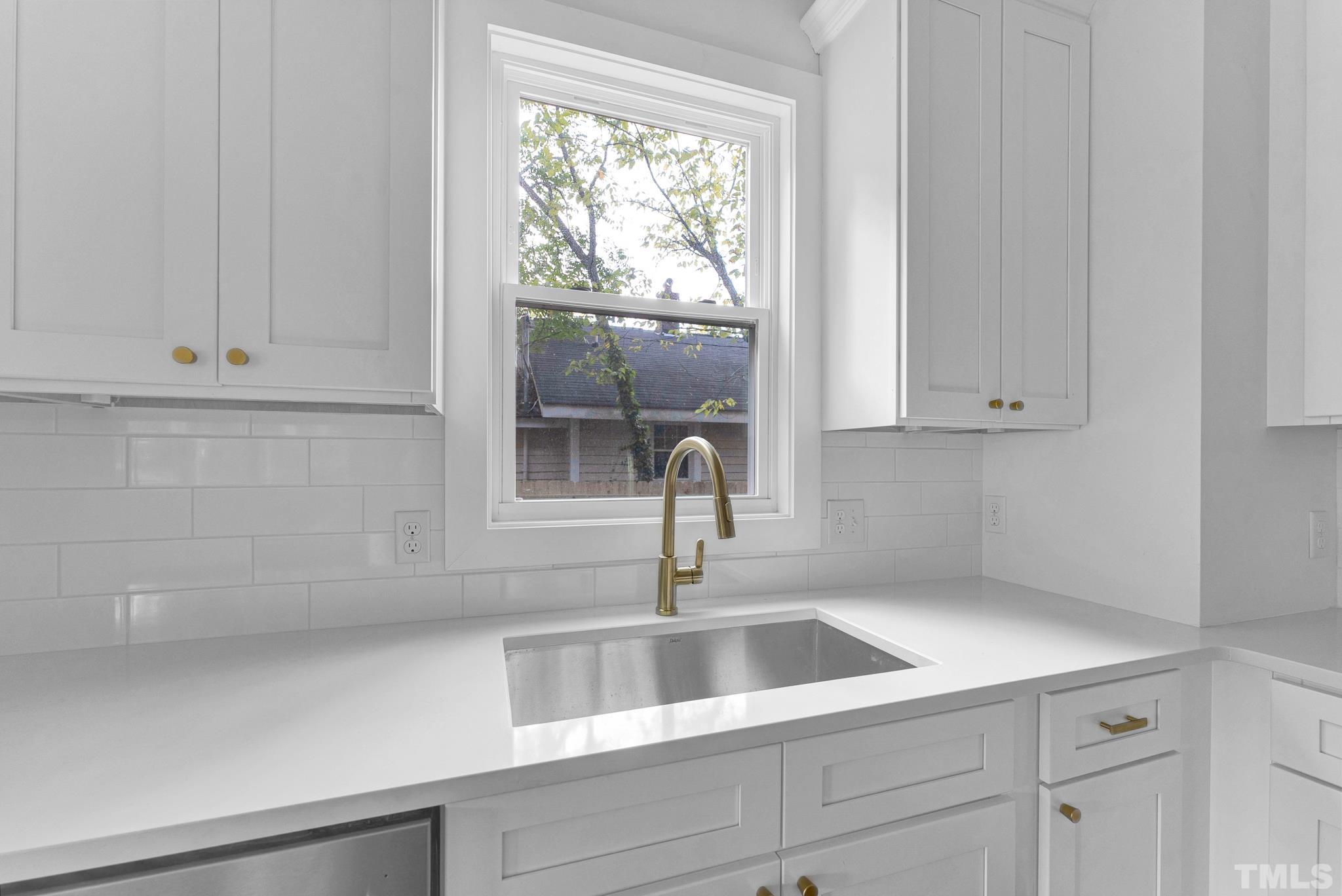 2311 Poole Road Raleigh, NC 27610 - Photo 12 of 29 a kitchen with a sink and cabinets