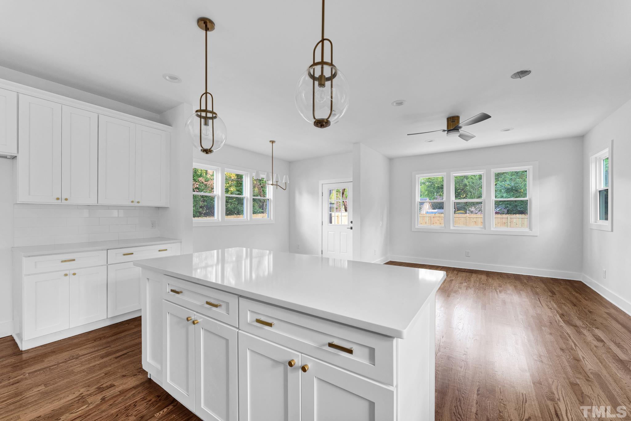 2311 Poole Road Raleigh, NC 27610 - Photo 13 of 29 a kitchen with granite countertop white cabinets and white appliances