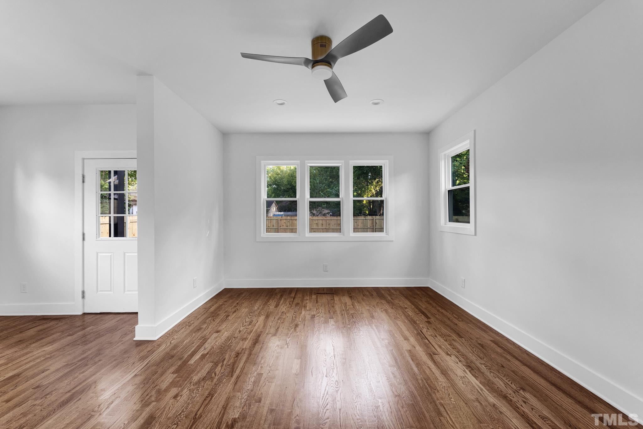 2311 Poole Road Raleigh, NC 27610 - Photo 14 of 29 a view of empty room with wooden floor and fan