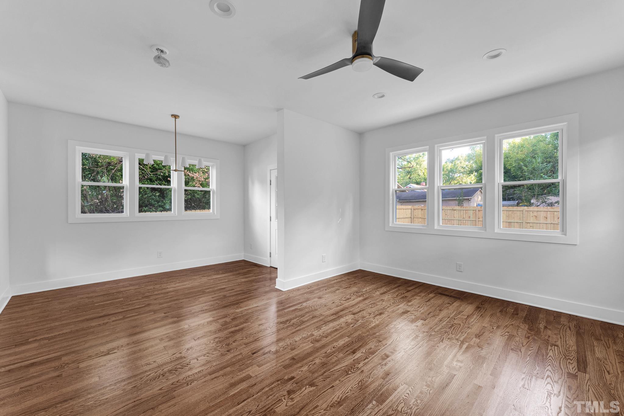 2311 Poole Road Raleigh, NC 27610 - Photo 15 of 29 a view of an empty room with wooden floor and a window