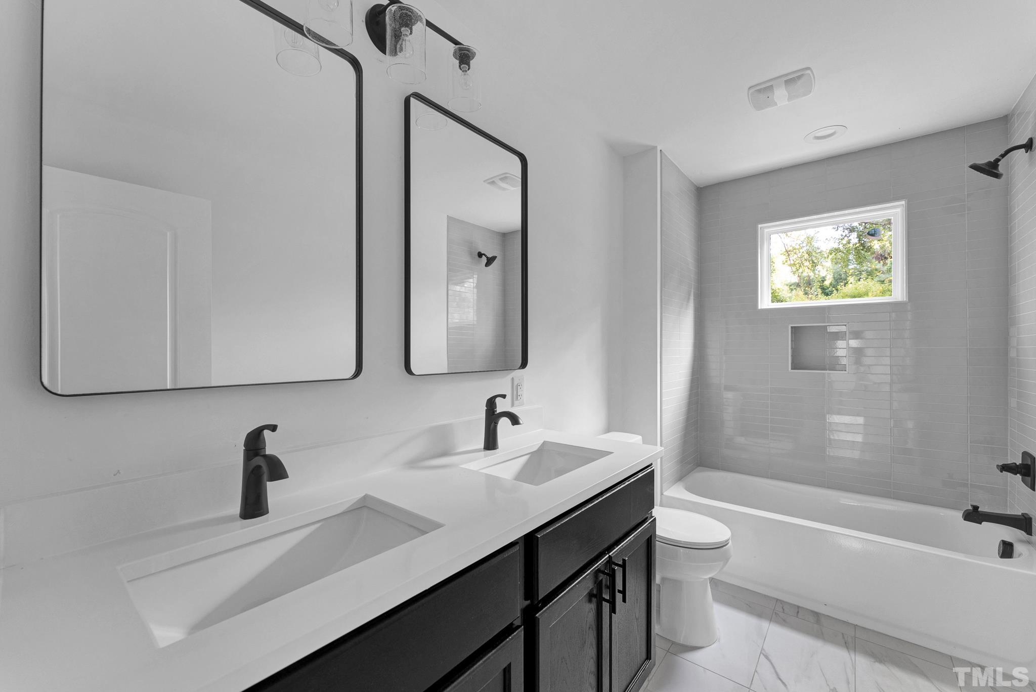 2311 Poole Road Raleigh, NC 27610 - Photo 25 of 29 a bathroom with a sink a toilet and a bathtub