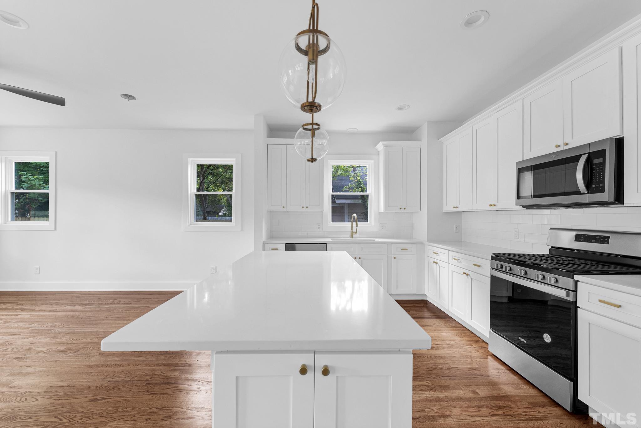2311 Poole Road Raleigh, NC 27610 - Photo 9 of 29 a kitchen with stainless steel appliances granite countertop a sink a stove top oven a counter space and cabinets