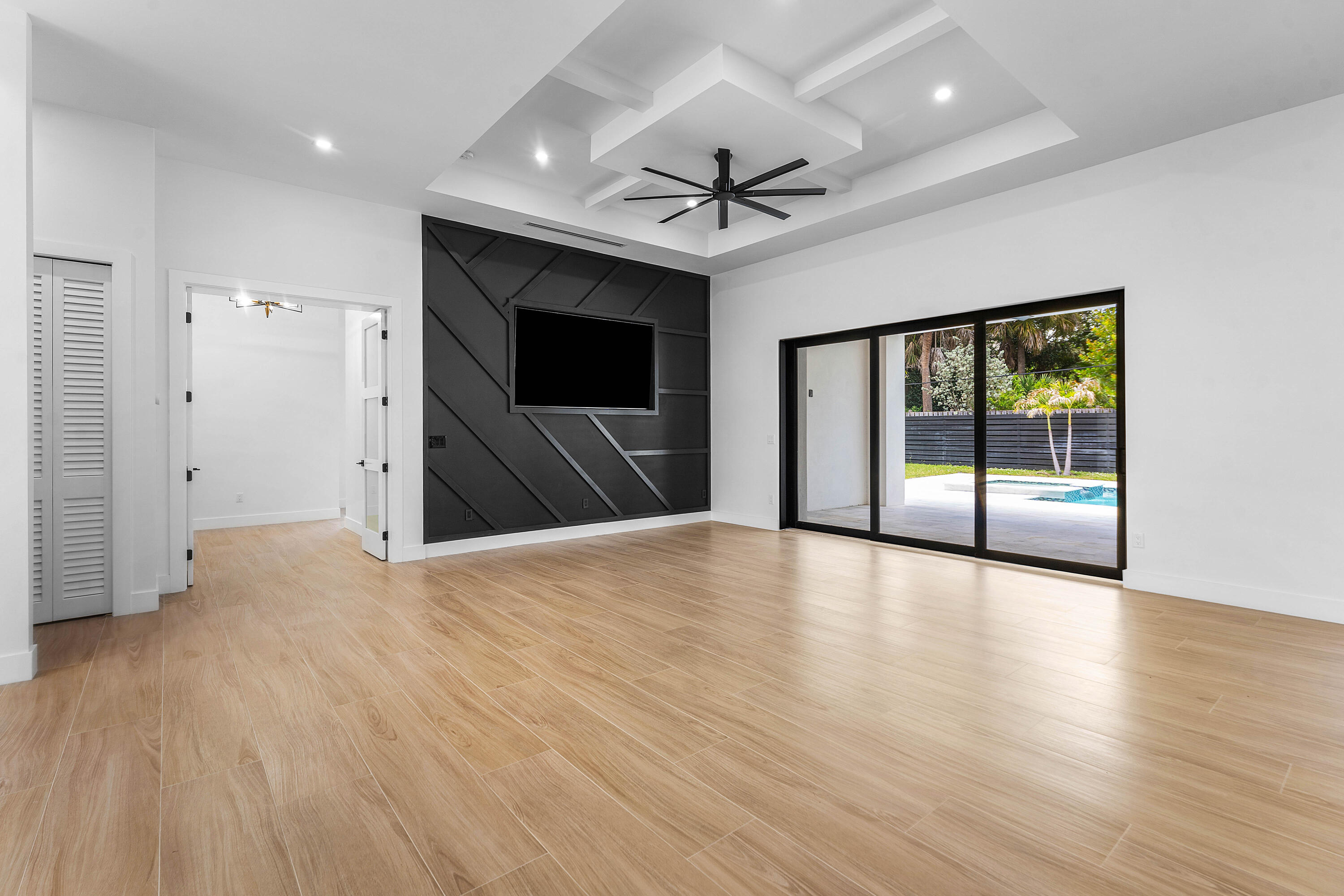5701 Old Orange Road Jupiter, FL 33458 - Photo 12 of 46 a view of a livingroom with wooden floor and a ceiling fan