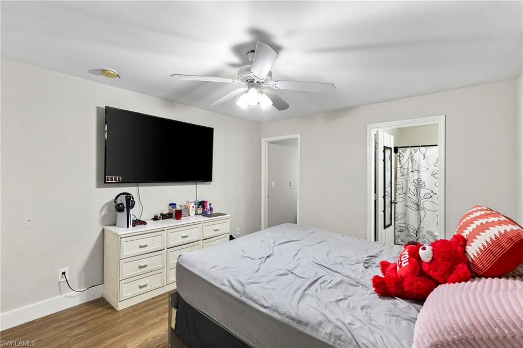 8264-8268 Matanzas Road Fort Myers, FL 33967 - Photo 23 of 33 a bedroom with a bed and a flat screen tv