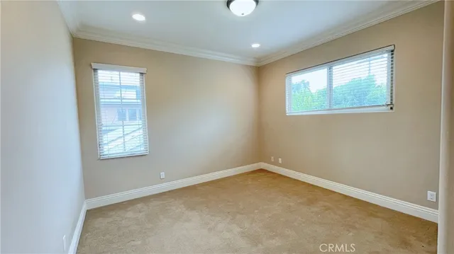 an empty room with windows and closet
