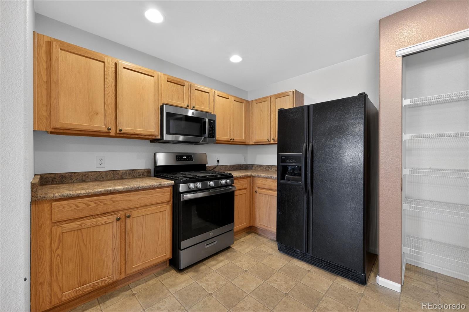 6603 Autumn Ridge Drive, Unit 2 Fort Collins, CO 80525 - Photo 11 of 33 a kitchen with stainless steel appliances granite countertop a refrigerator stove and microwave