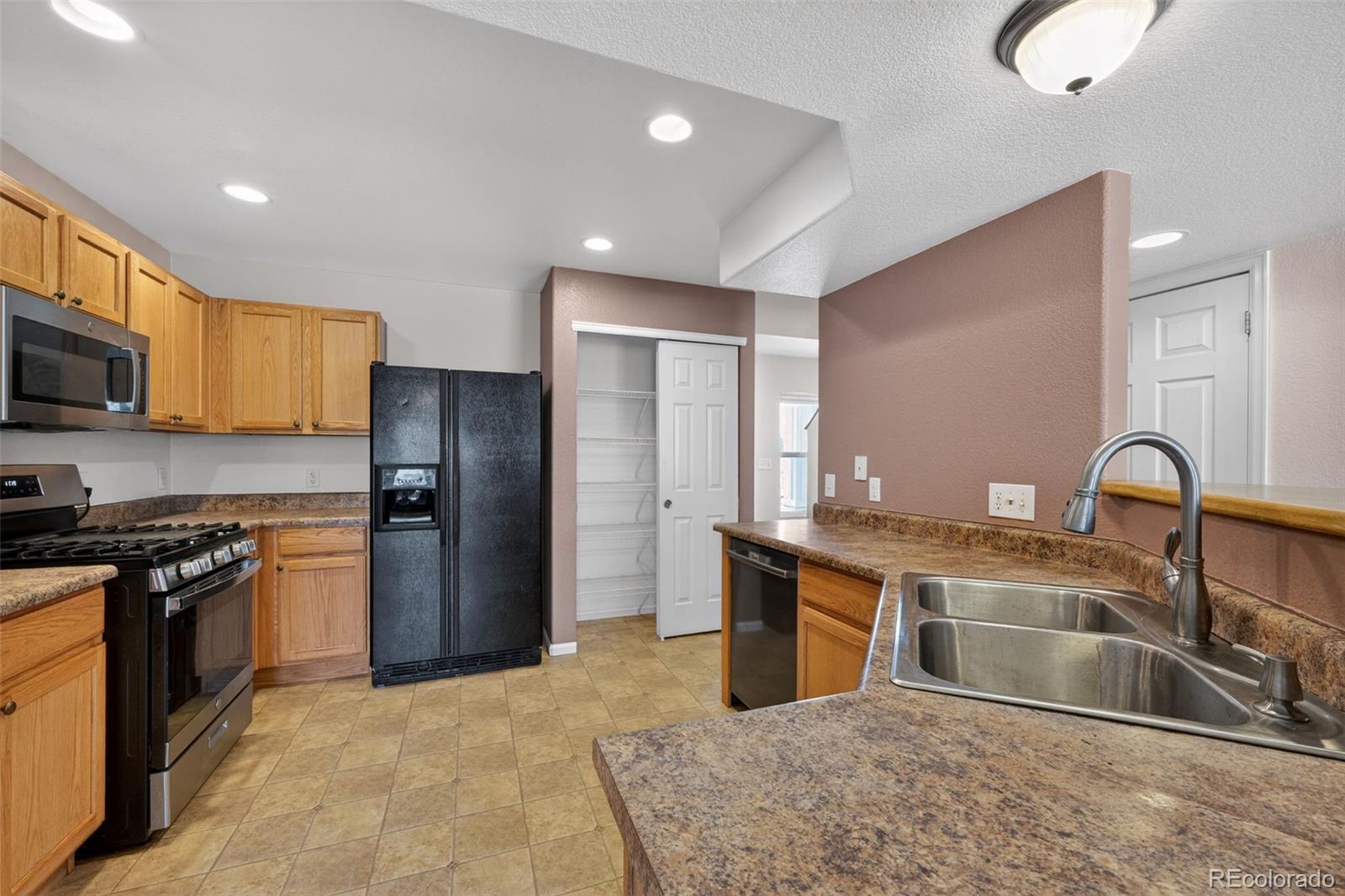 6603 Autumn Ridge Drive, Unit 2 Fort Collins, CO 80525 - Photo 12 of 33 a kitchen with stainless steel appliances granite countertop a sink stove and refrigerator