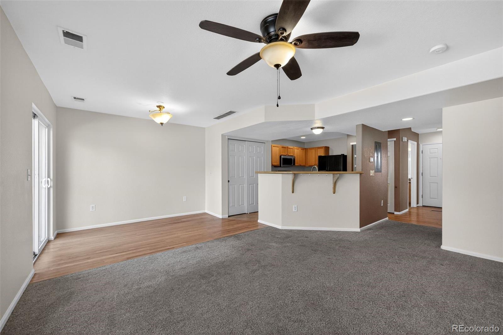 6603 Autumn Ridge Drive, Unit 2 Fort Collins, CO 80525 - Photo 13 of 33 a view of a kitchen with a microwave and a ceiling fan