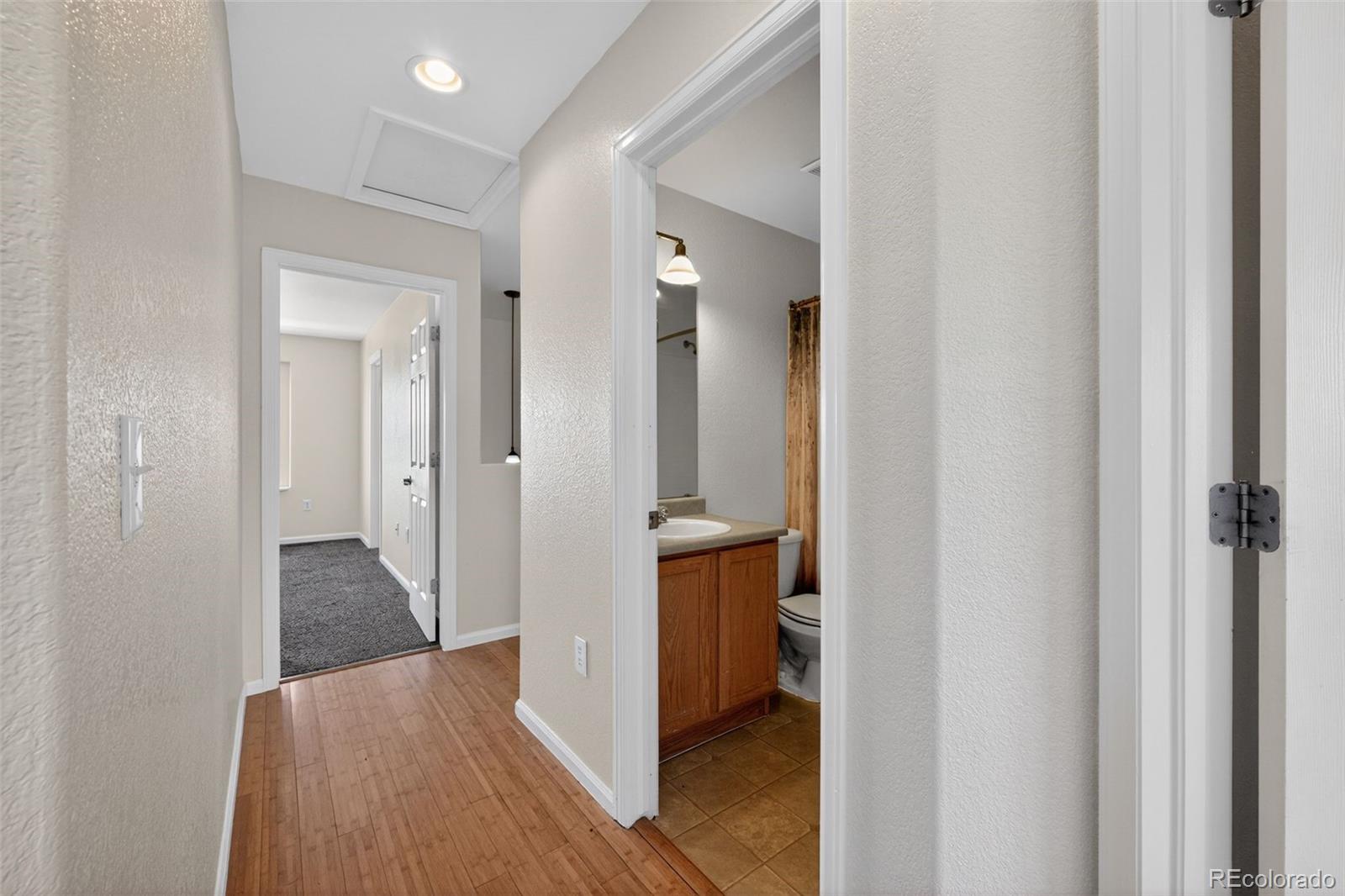 6603 Autumn Ridge Drive, Unit 2 Fort Collins, CO 80525 - Photo 17 of 33 a view of a bathroom with tub shower bedroom and wooden floor