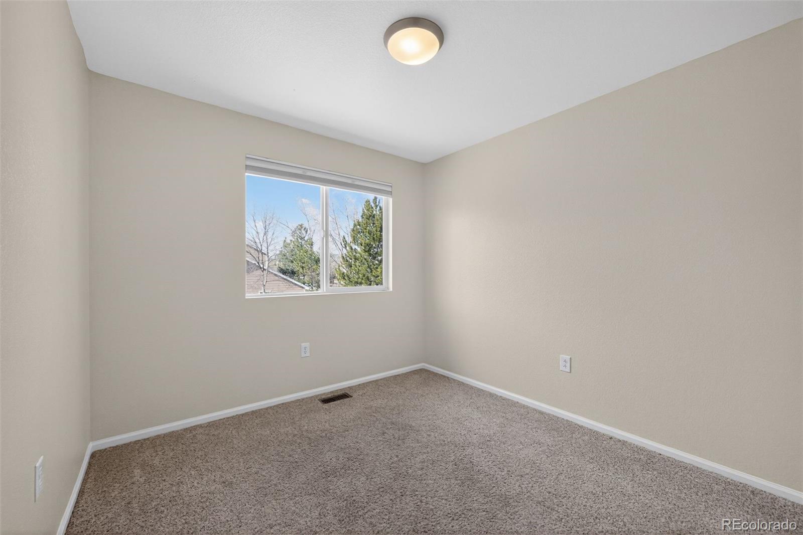 6603 Autumn Ridge Drive, Unit 2 Fort Collins, CO 80525 - Photo 18 of 33 an empty room with windows