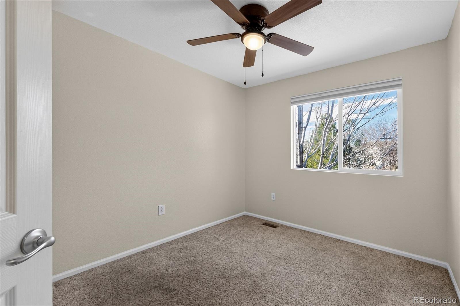 6603 Autumn Ridge Drive, Unit 2 Fort Collins, CO 80525 - Photo 20 of 33 an empty room with a window and a fan