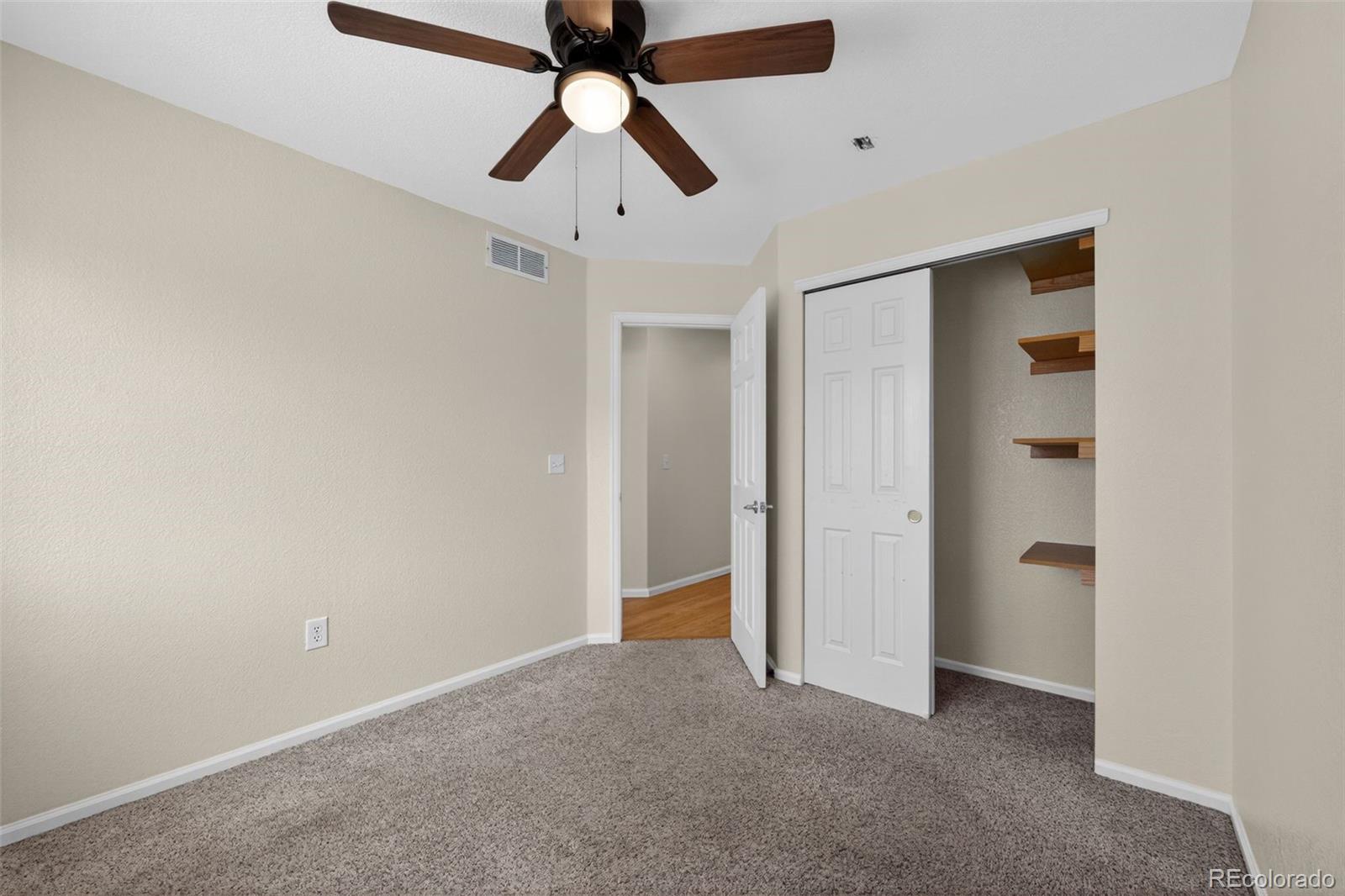 6603 Autumn Ridge Drive, Unit 2 Fort Collins, CO 80525 - Photo 23 of 33 an empty room with a ceiling fan and a window