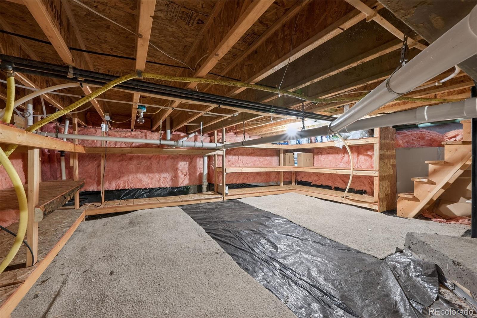 6603 Autumn Ridge Drive, Unit 2 Fort Collins, CO 80525 - Photo 31 of 33 a view of a garage with wooden cabinets